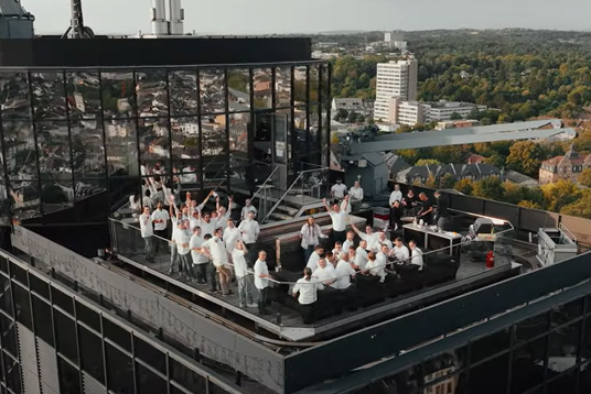 blue automation employees stand together on a high-rise rooftop