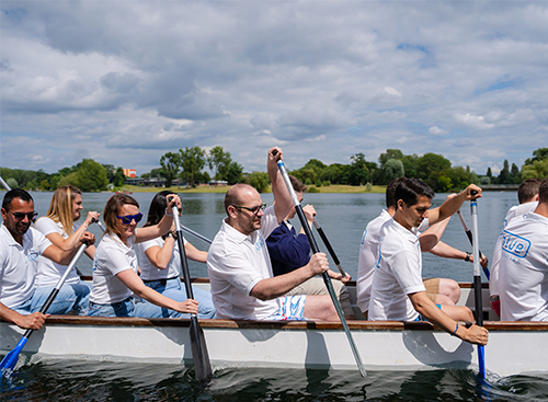 blue automation employees rowing on the water