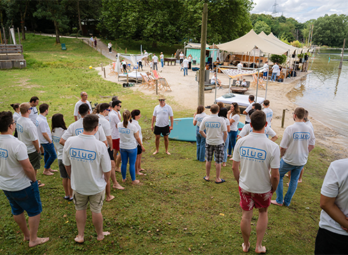 blue automation employees stand together in a group